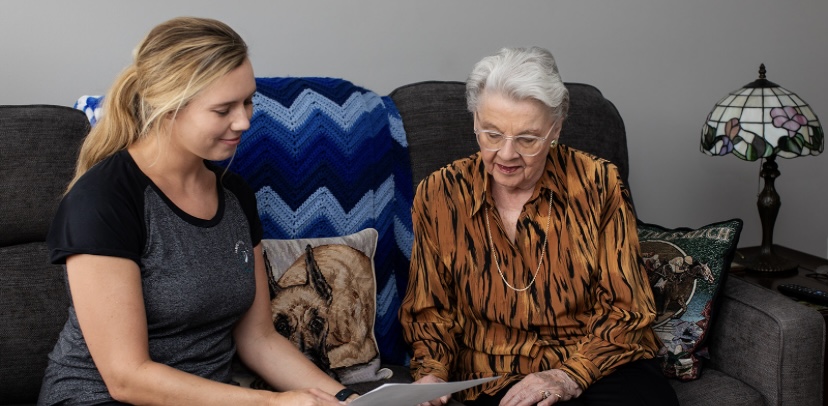 Cindy Bush reviewing a move plan with a client at home